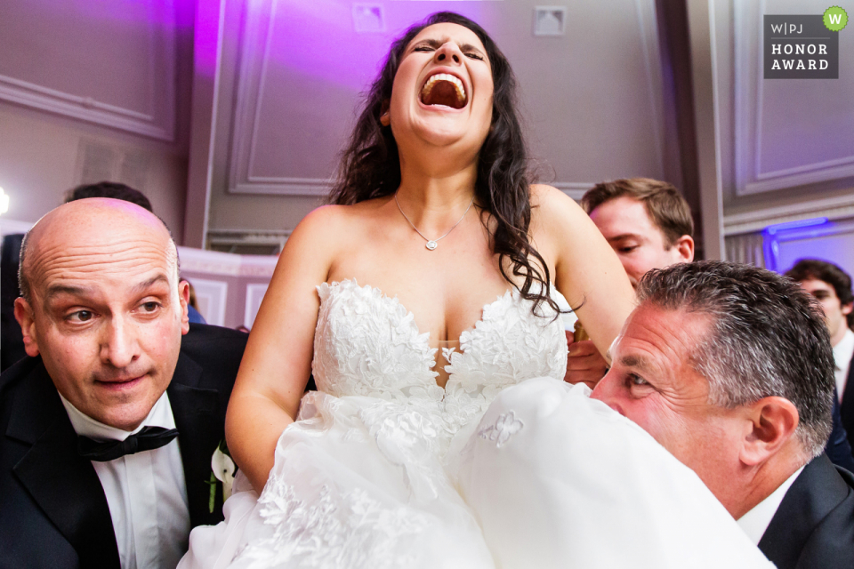 Photo by: <a href="https://www.wpja.com/contests/2019-v12-photography-competition/best-wedding-photographers/2548232">Michelle Arlotta - Milford New Jersey</a> The View on the Hudson, Piermont, NY wedding photo | Bride about to be lifted up during the Horah at The View on The Hudson Wedding in New York