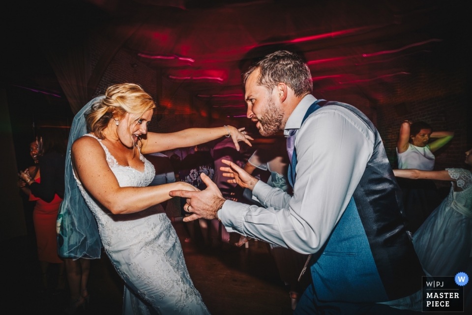 two Kent dance fiends in action Hales Hall Barn, Suffolk Wedding Venue Photographer: A snippet of these two dance fiends in action - they were unstoppable!