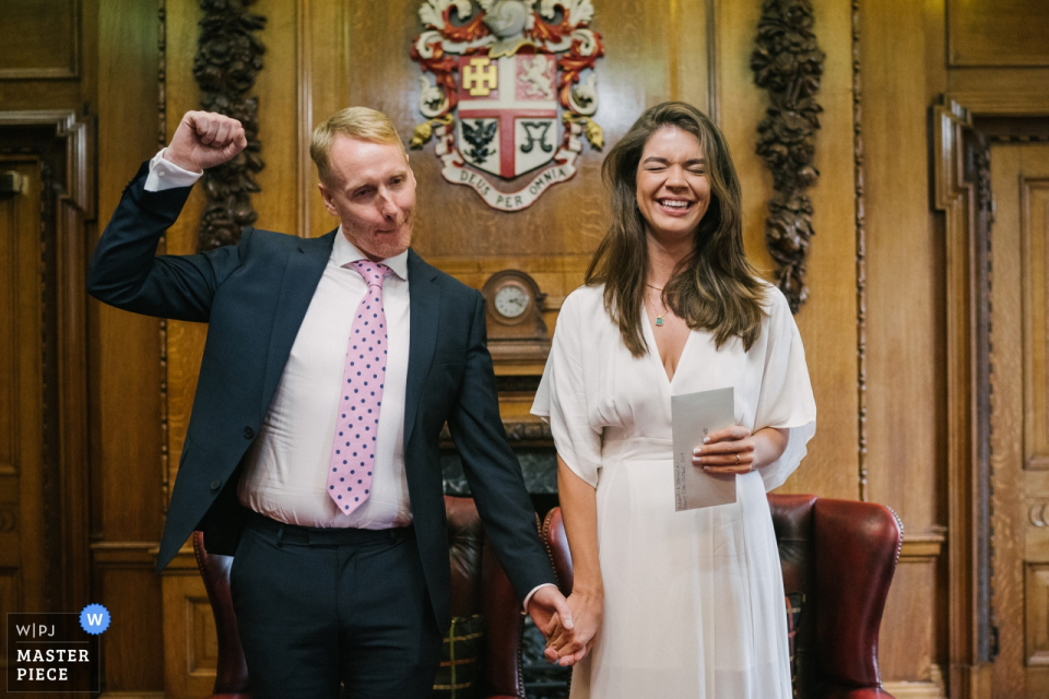 Foto: <a href="https://www.wpja.com/contests/2019-v16/best-wedding-photographers/2560496"> Kari Bellamy - London </a> Hochzeitsfotografie von Islington Town Hall, London, UK | Bräutigam, der nach dem Heiraten feiert