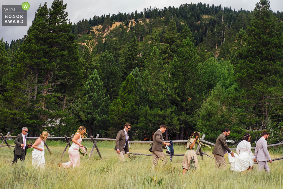 Sierra High Camp wedding ceremony photo Squaw Valley Sierra High Camp wedding ceremony photo at the venue: Bridal party exit meadow as it starts to rain