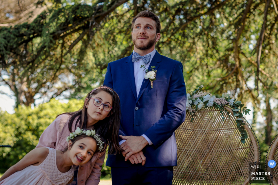 Photo by: <a href="https://www.wpja.com/contests/2019-v19/best-wedding-photographers/2569555">Florent Cattelain - Labarthe-sur-Lèze </a> Chateau de Tauzies, France wedding photography contains: The groom and little girls waiting the bride