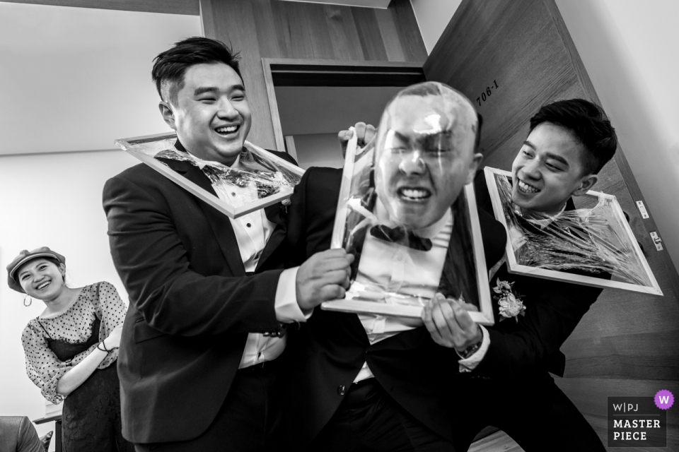 Light Wedding Banquet Hall - Photo on Wedding Day - The groomsmen were trying to break the plastic wrap with face in the bridal game time.