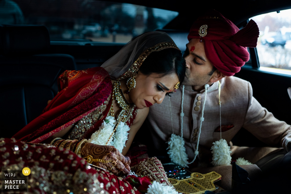 Embassy Suites St Charles Missouri wedding photographer: The couple cries together before driving off