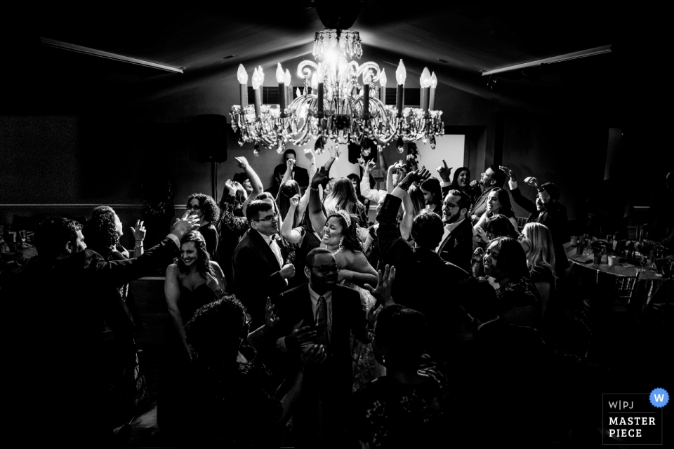Bride and Groom in the center of a hectic dance floor Top of the Town - Arlington VA - Wedding photo of the Bride & Groom in the center of a hectic dance floor with epic backlight