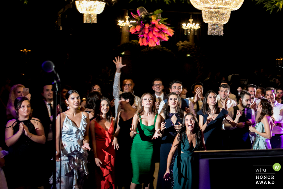 JW Marriott Ankara wedding venue photo - Bridesmaids are trying to catch the bouquet 