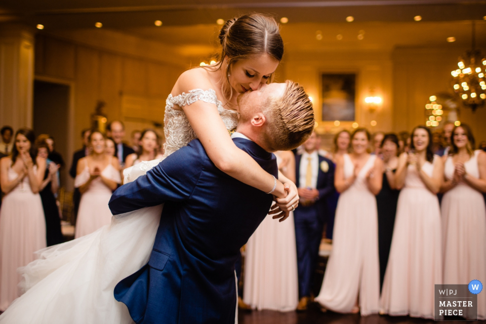 the bride and groom surrounded by guests clapping Army Navy Country Club, Arlington VA | First Dance photo of the bride and groom surrounded by guests clapping