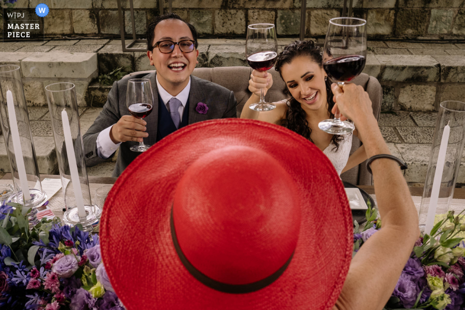 Photo by: <a href="https://www.wpja.com/contests/2021-v02/best-wedding-photographers/2633642">Nikhol Esteras - Oaxaca de Juárez Oaxaca</a> Jardin Etnobotanico, Oaxaca City outdoor marriage reception party award-winning photo that has recorded the Cheers to the newlyweds. The world's top wedding photographers compete at the WPJA