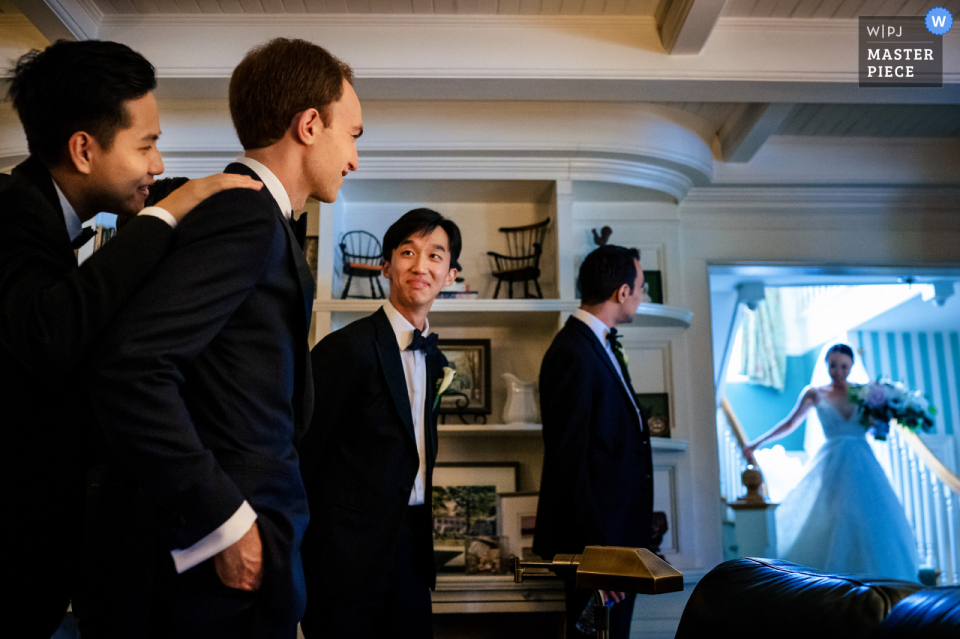 The groom, surrounded by his loved ones, was moved as he watched the bride make her grand entrance, captured by a photographer in Manchester, VT