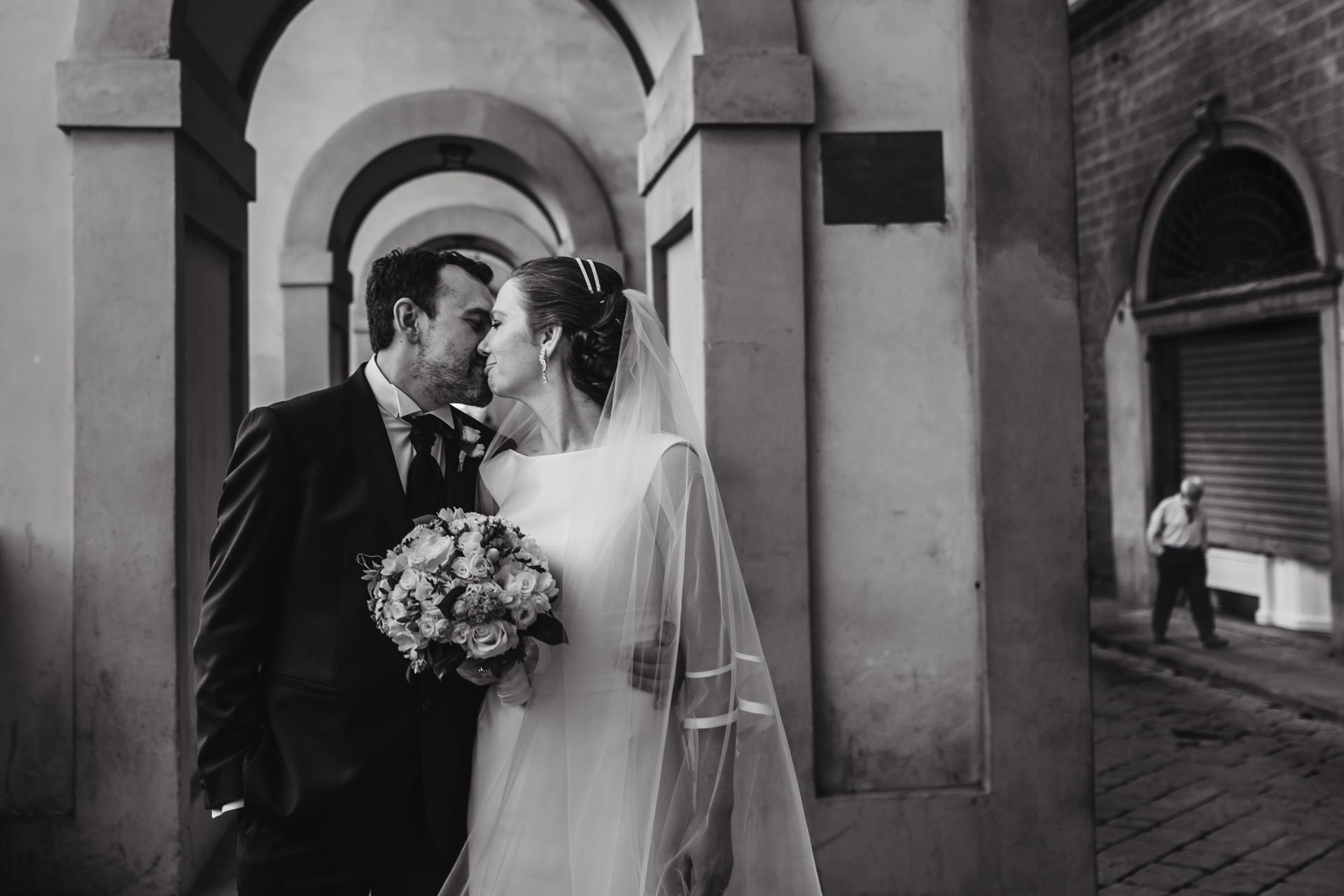 Italy Wedding Portraits - the bride and groom take this opportunity to show their love for one another as they walk together through the cobblestone streets Florence Couple Elopement Photos | The streets of Florence are eerily quiet, but the couple doesn’t mind