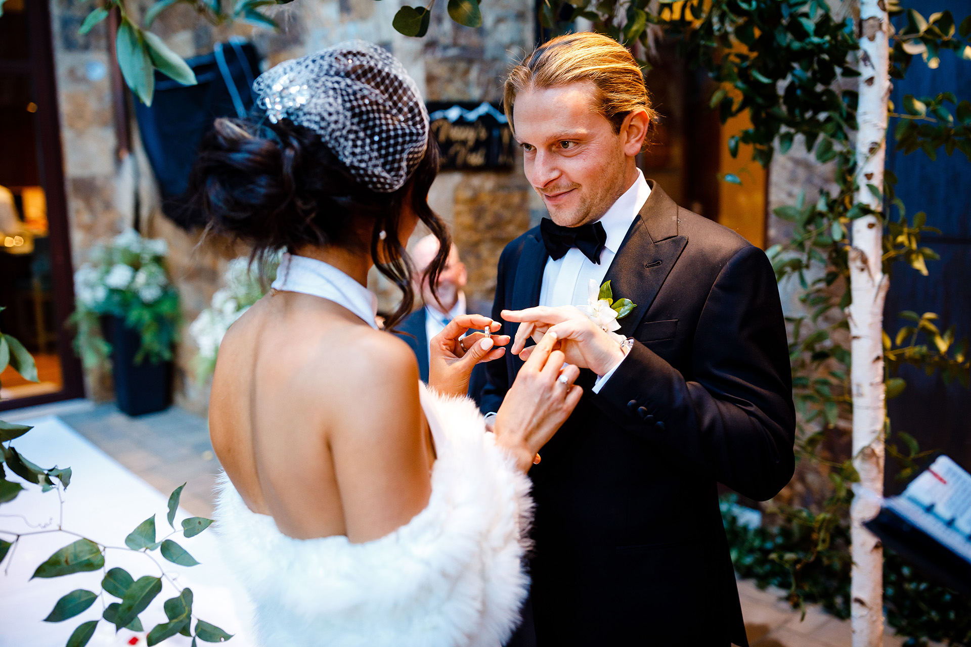 Vail, CO Wedding Photography | The bride prepares to place the ring on the grooms finger 