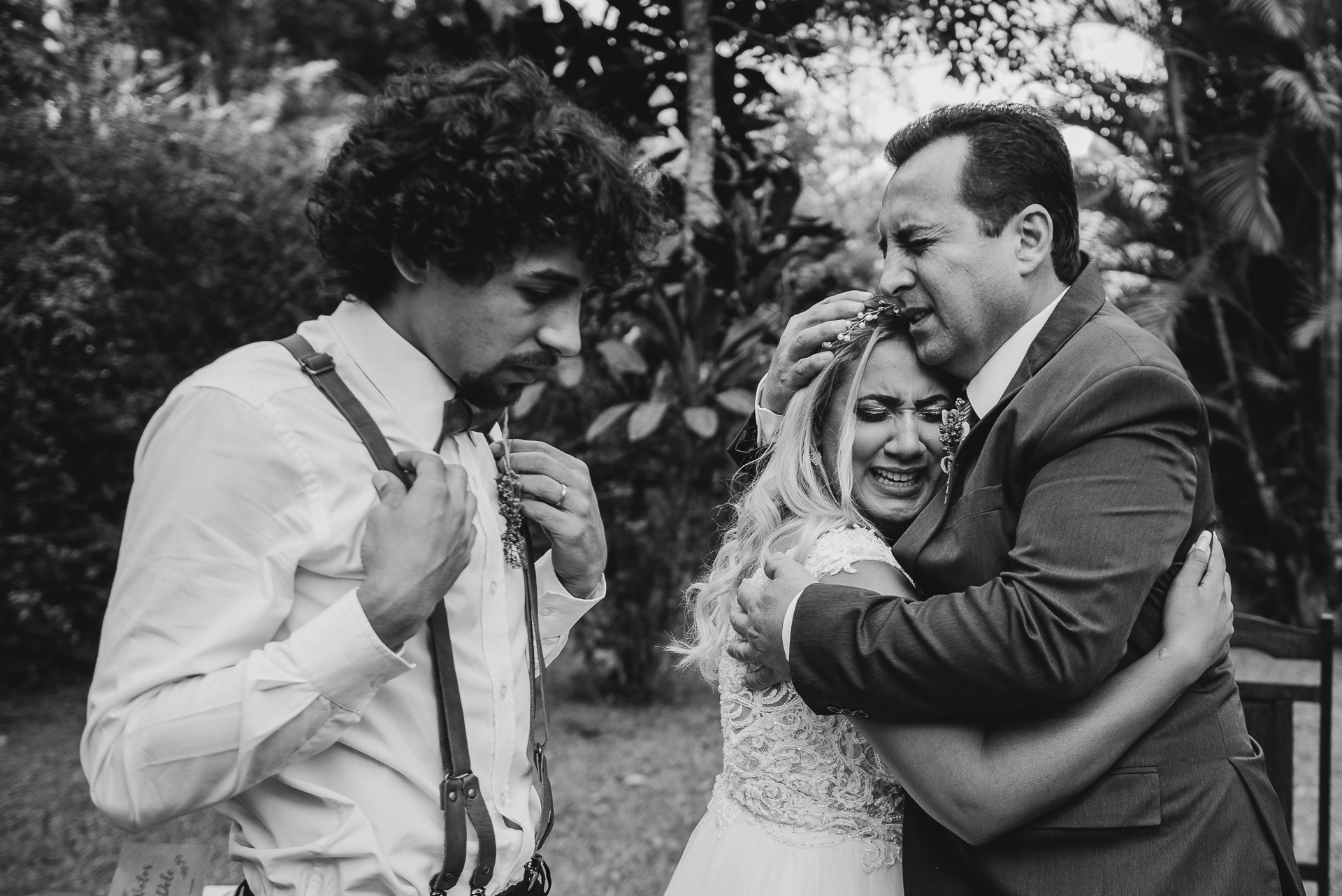 Brazilian Black and White Wedding Photos | The bride shares an emotional hug with her new father in law