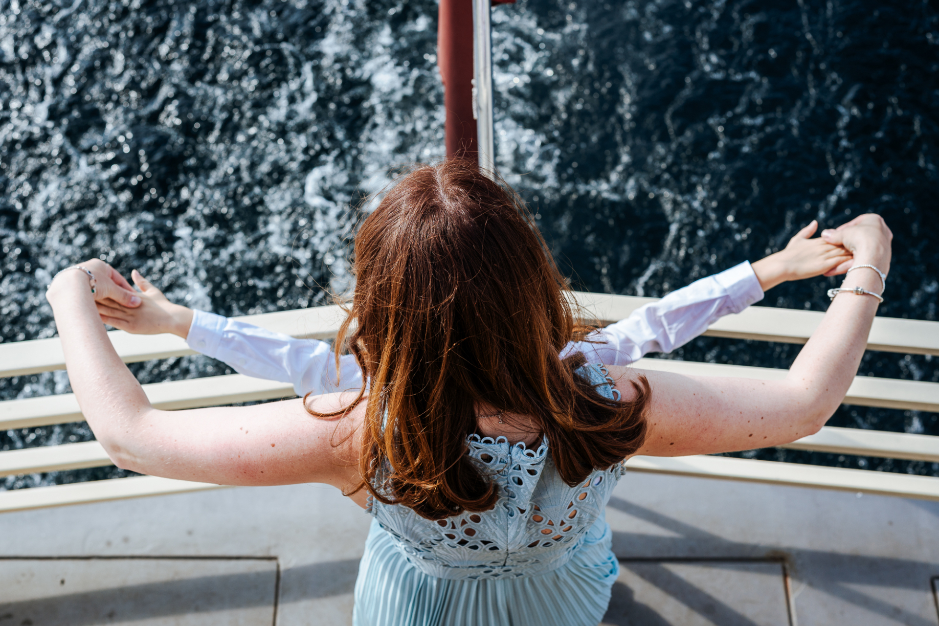 Young wedding party members perform Titanic scene on Rutland Belle boat.