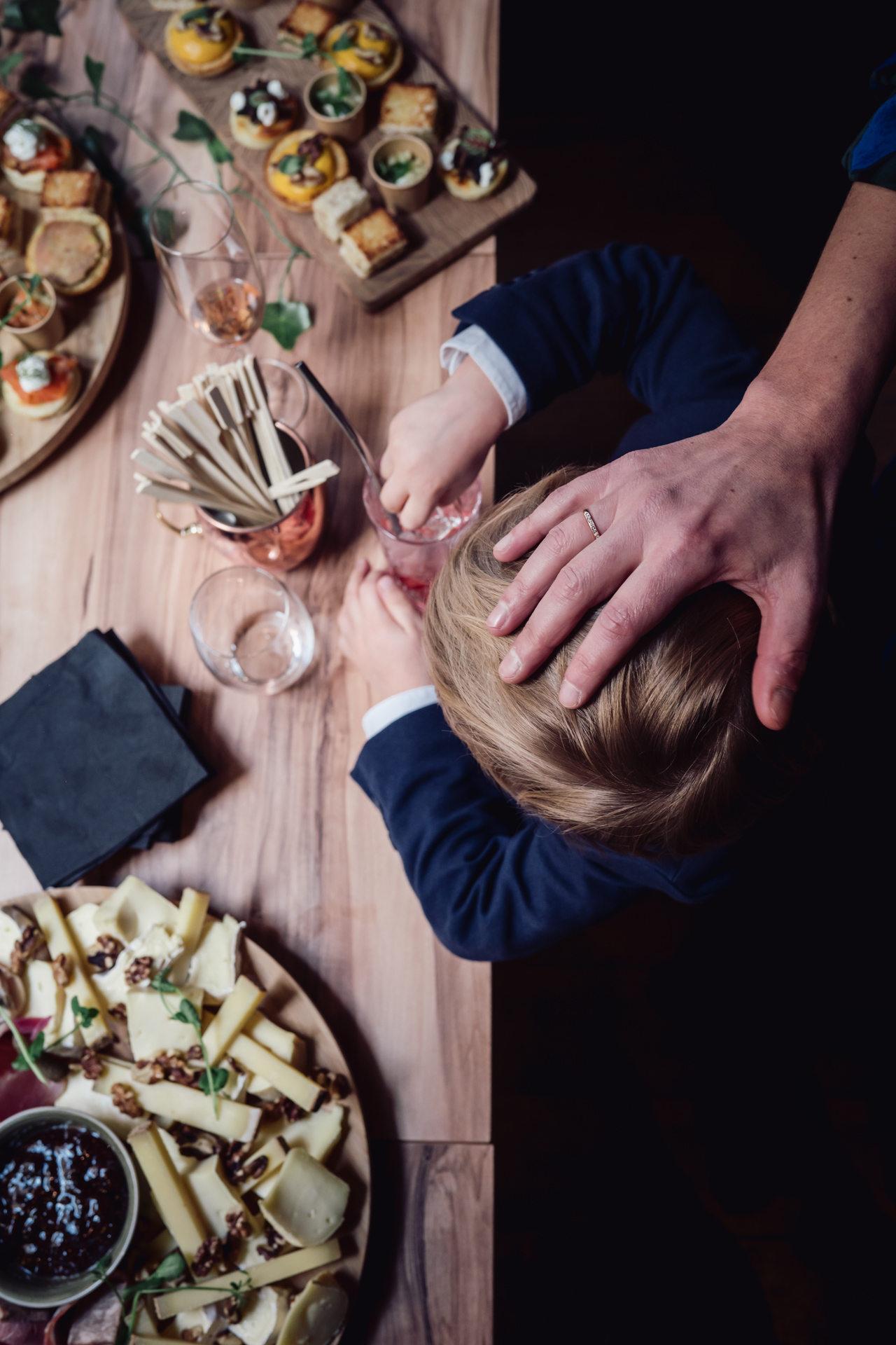 A young guest in Lyon serves himself food at the buffet during wedding celebration.